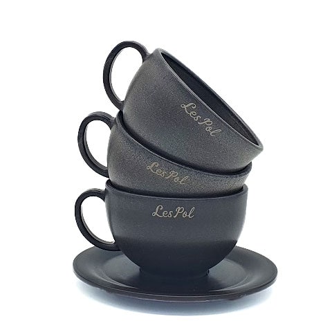 Three black coffee cups stacked on top of one another, showcasing a sense of balance.