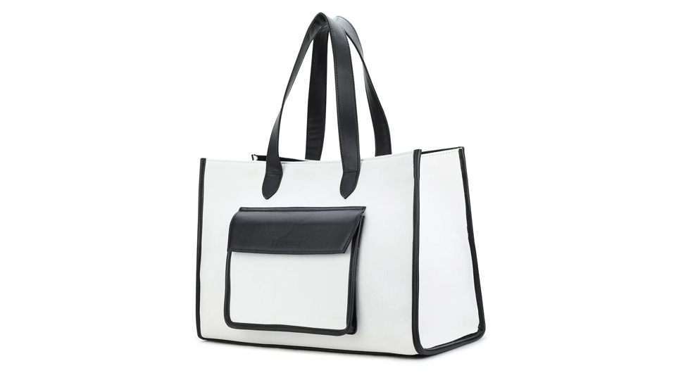 A stylish white tote bag with black trim and handles is shown. It features a front pocket with a flap, perfect for keeping your directory organized. The bag's clean lines and contrasting colors give it a modern, sophisticated appearance.